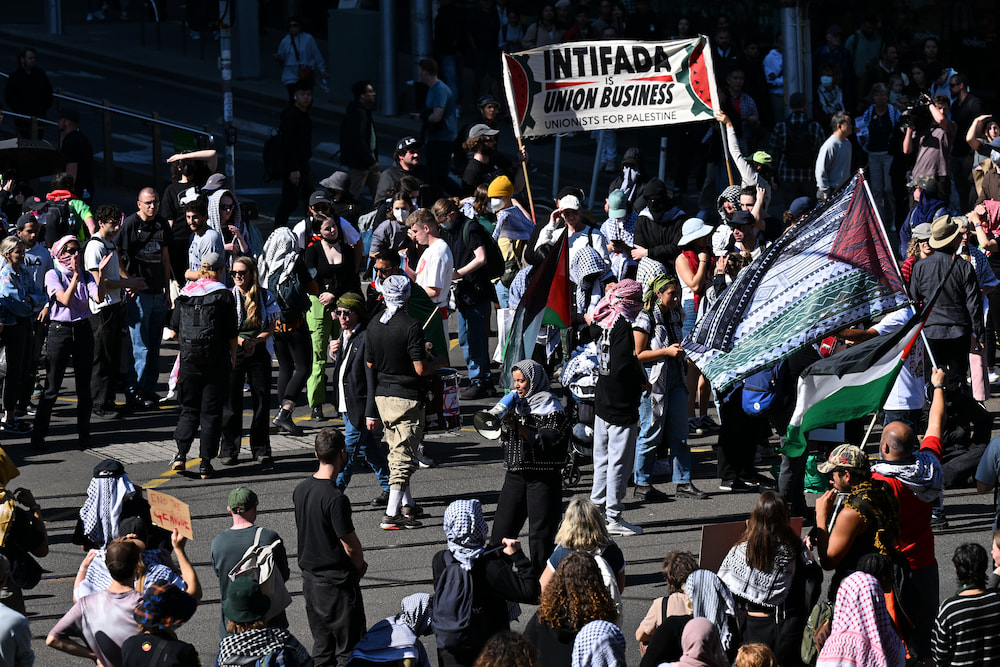 Protesters block the intersection of Bourke and Spencer street during a Pro-Palestine protest in Melbourne. (AAP Image/James Ross)