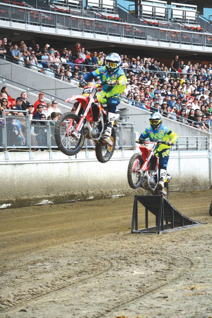 two people doing stunts on dirt bikes at The ActewAGL Royal Canberra Show