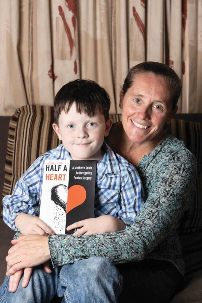 Libby with her son Andrew who has CHD holding her book