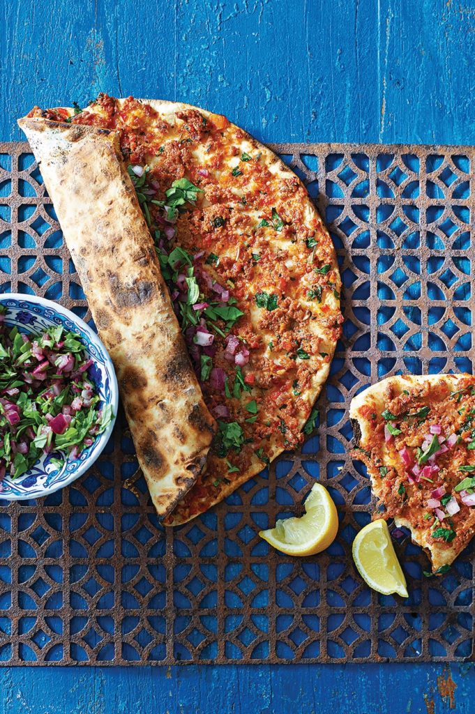 food from around the world with a thin crust pide and spicy lamb topping