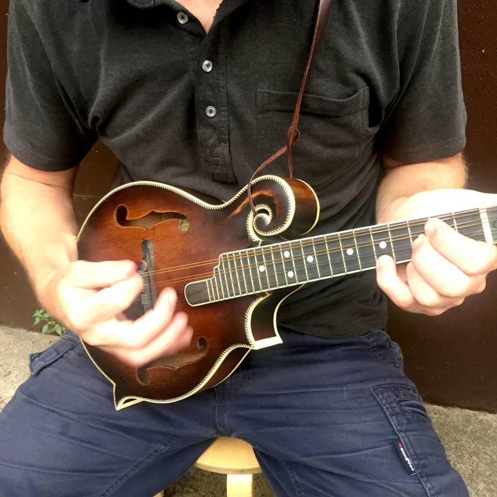 Luke Heggie playing his mandolin