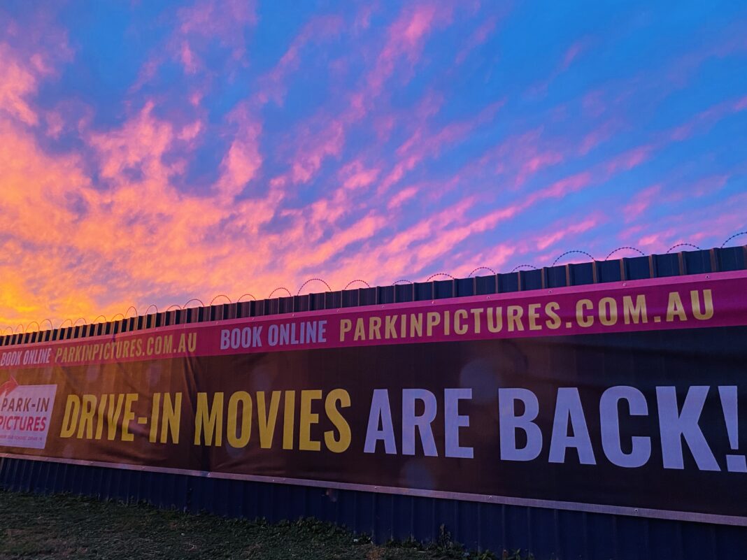 drive-in movies sign at dusk