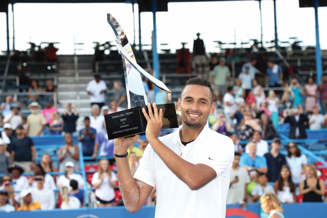 nick kyrgios holding a trophy up in front of crowd