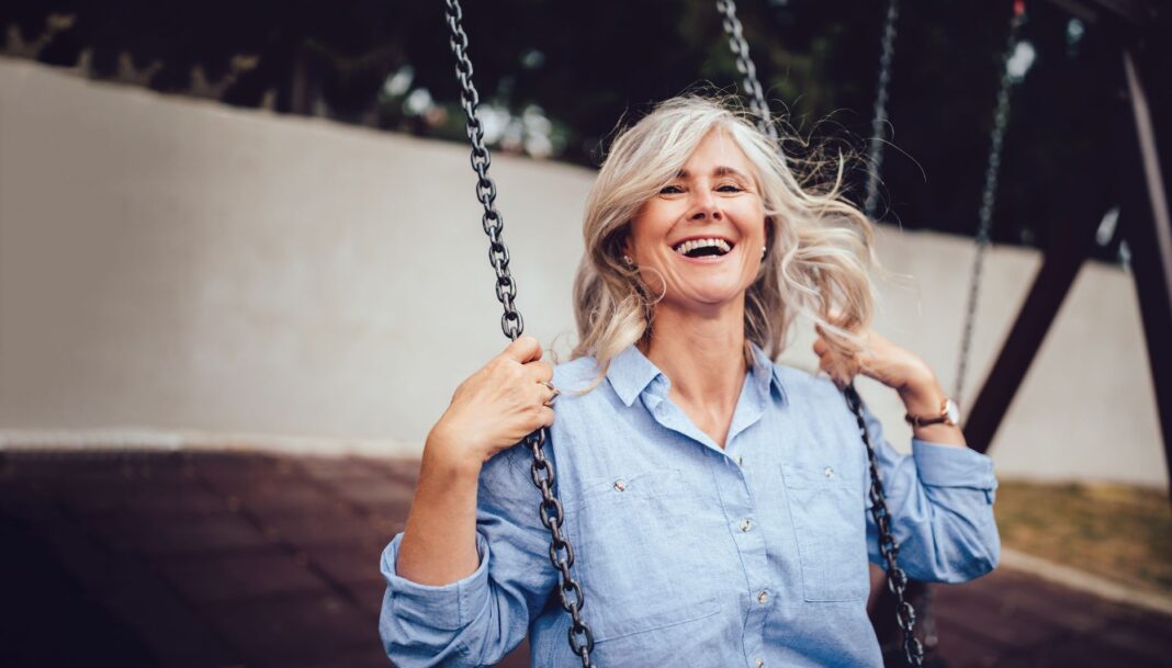 woman smiling on a swing