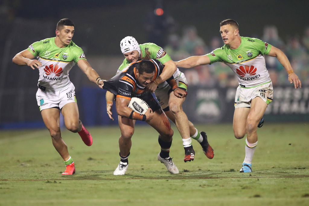 Raiders players swamp Tigers centre Joseph Leilua