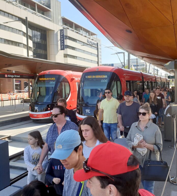 people getting off tram in city