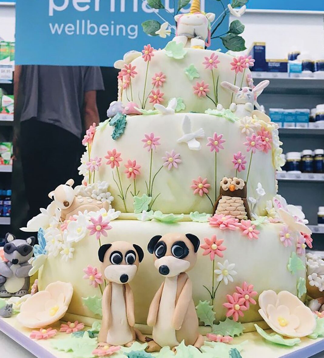 large cake with animals made out of cake on it