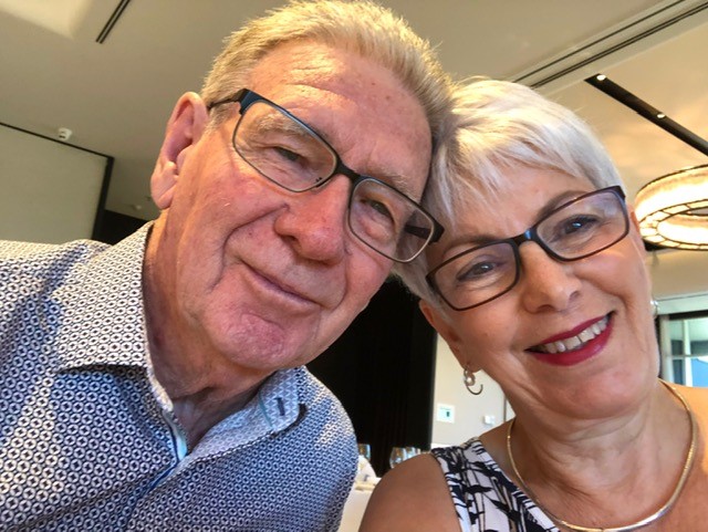 Selfie of smiling older man and woman wearing glasses