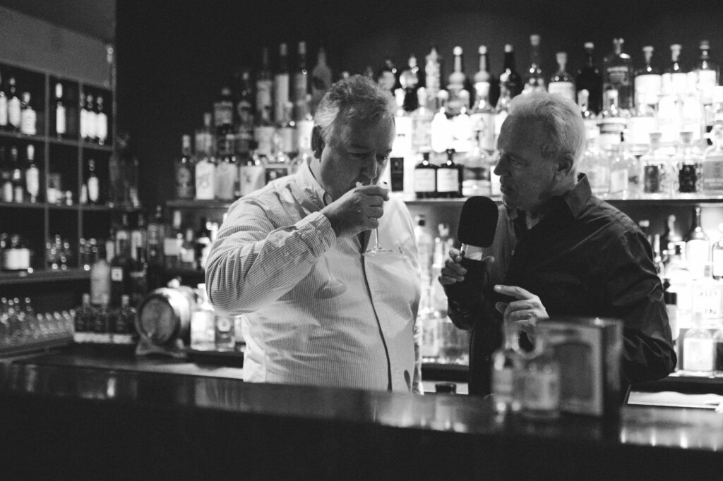two men sipping gin