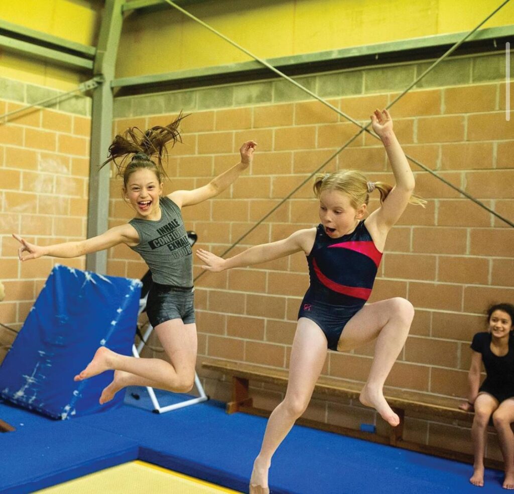 2 girls doing gymnastics