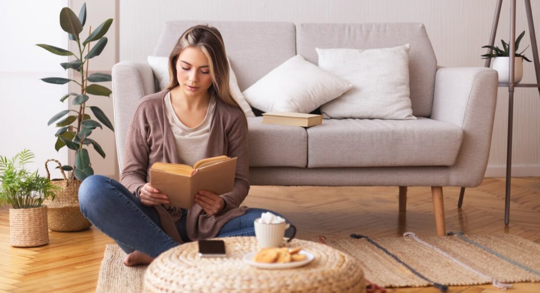 woman sitting down reading a book