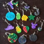 Collection of colourful keyrings spread out on a black tabletop