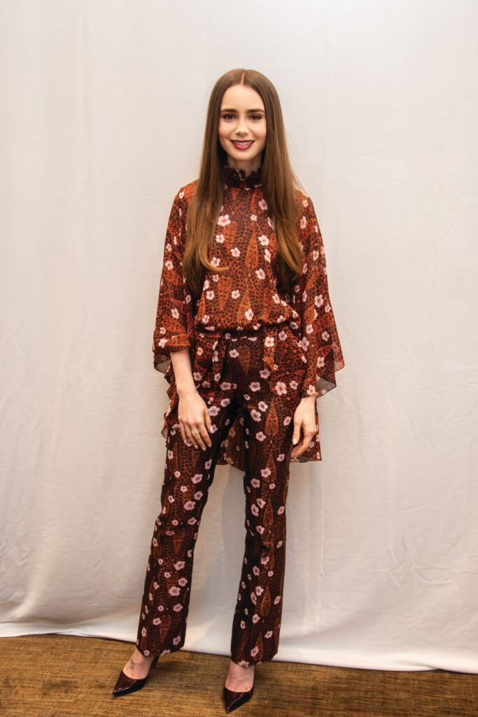 Lily Collins posing for the camera in a brown outfit