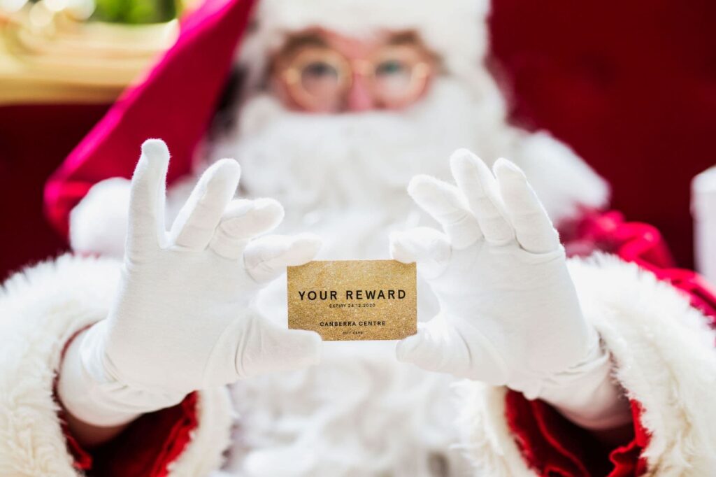 Santa holding a gift card