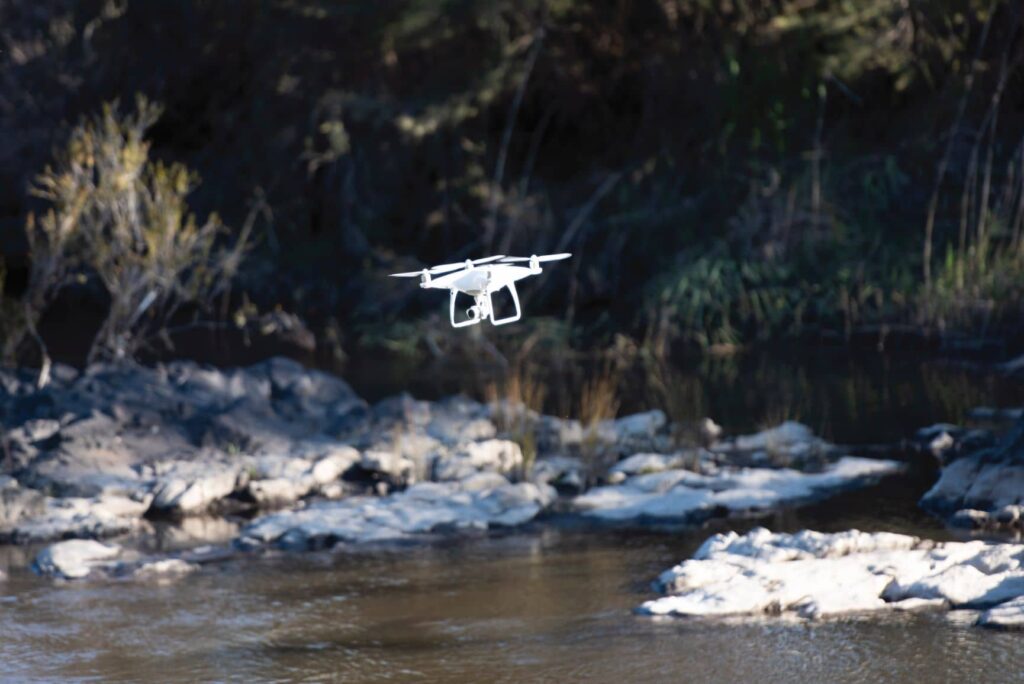 drone flying over a creek