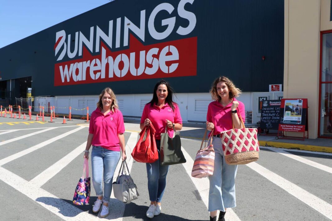 three women in pink out front of Bunnings