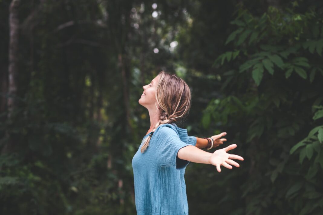 woman with her arms out and smiling