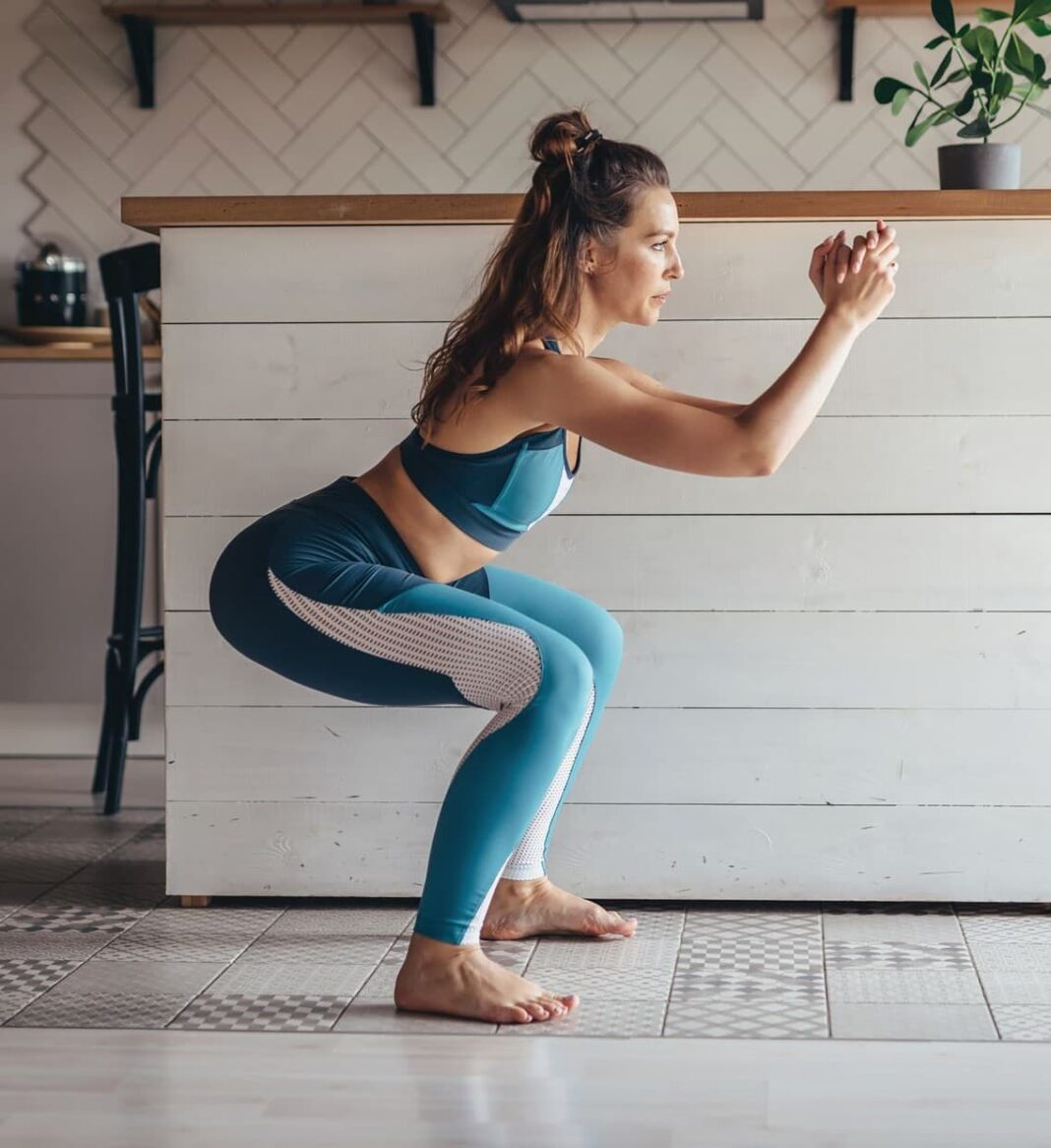 a woman doing a squat