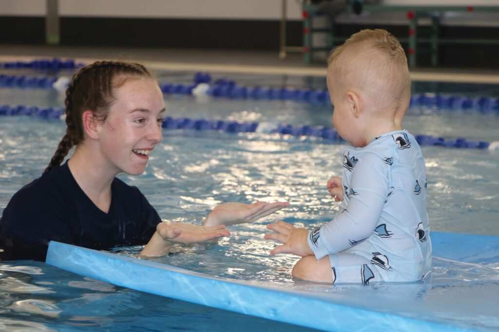 young child enjoying a swimming lesson