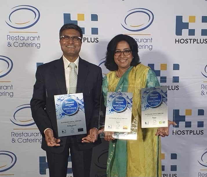 Image of Chefs Sanjay and Sunita Kumar with three R&CA Awards