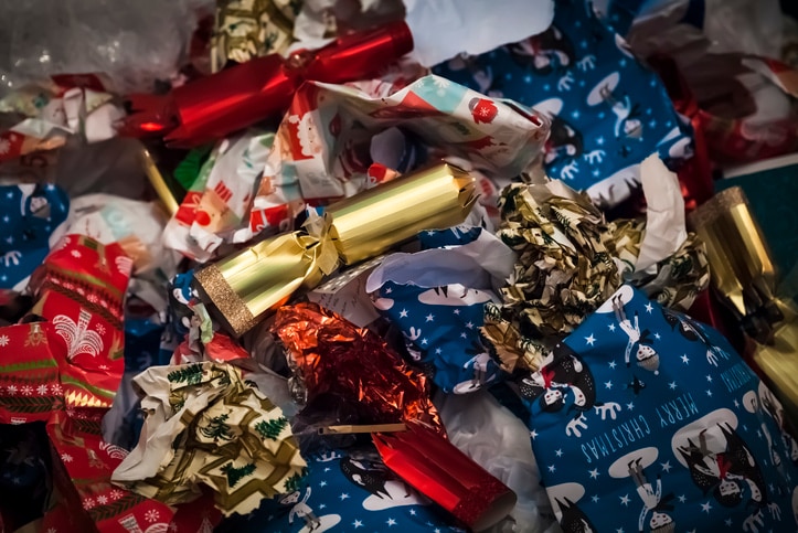 Pile of discarded Christmas wrapping paper, ribbon and bonbons