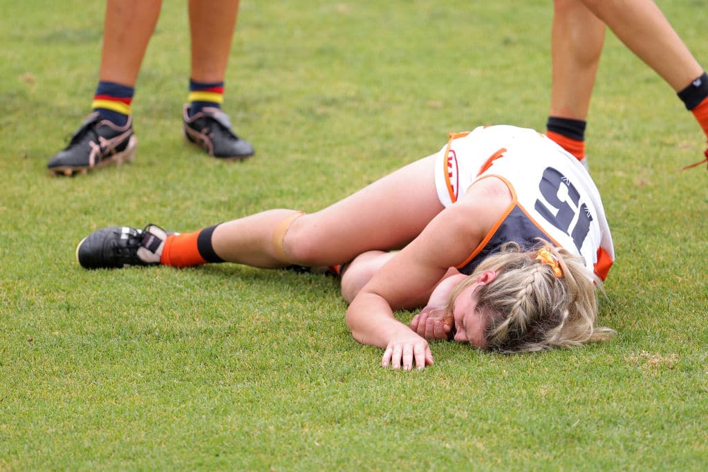 ADELAIDE, AUSTRALIA - JANUARY 17: Brid Stack of the Giants lays on the ground injured during the AFLW pre-season match between the Adelaide Crows and the GWS Giants at Norwood Oval on January 17, 2021 in Adelaide, Australia. (Photo by Daniel Kalisz/Getty Images)