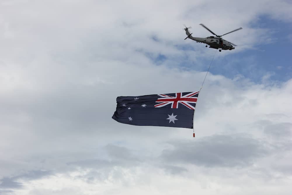 Australian flag flying under a helicopter