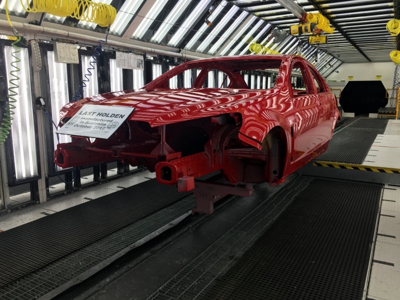 the body of the last australian-made Holden suspended in the workshop.