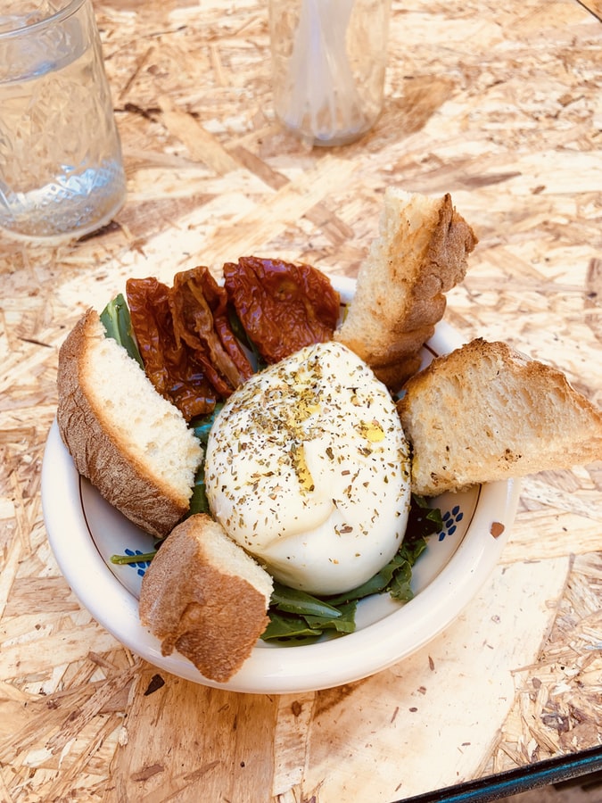A bowl of bread, sundried tomatoes and burrata. Share plate is in the running for Word of the Decade. 