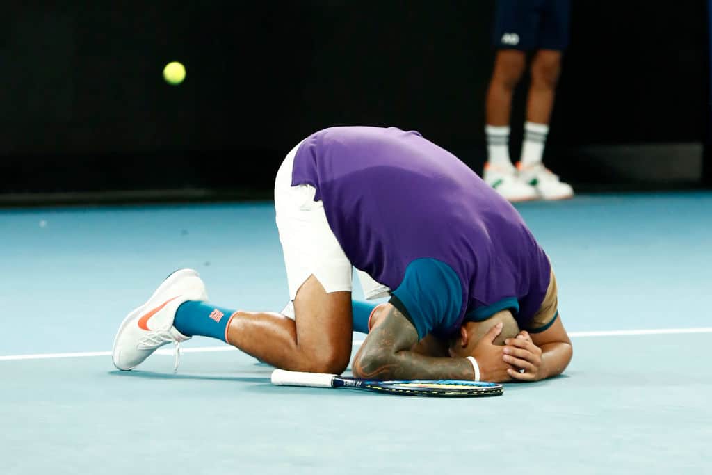 MELBOURNE, AUSTRALIA - FEBRUARY 10: Nick Kyrgios of Australia collapses to the ground after winning his Men's Singles second round match against Ugo Humbert of France during day three of the 2021 Australian Open at Melbourne Park on February 10, 2021 in Melbourne, Australia. (Photo by Darrian Traynor/Getty Images)