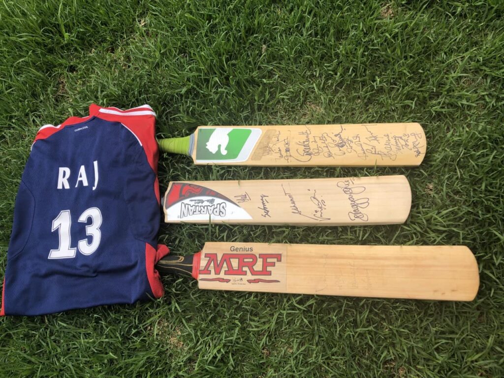 three cricket bats with autographs