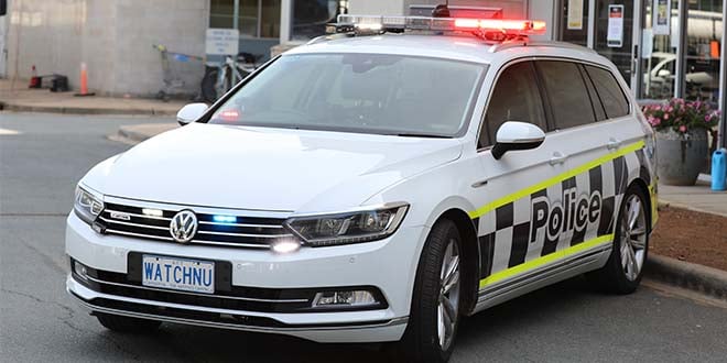 white police car with WATCHNU registration plate
