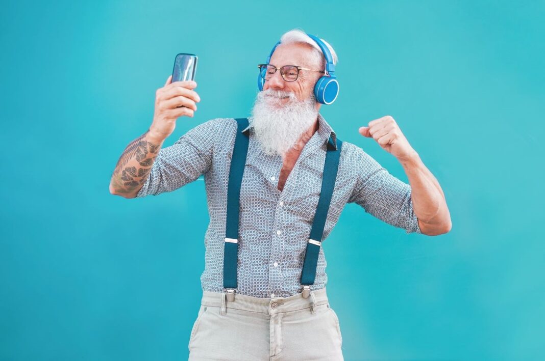 elderly man with headphones on dancing