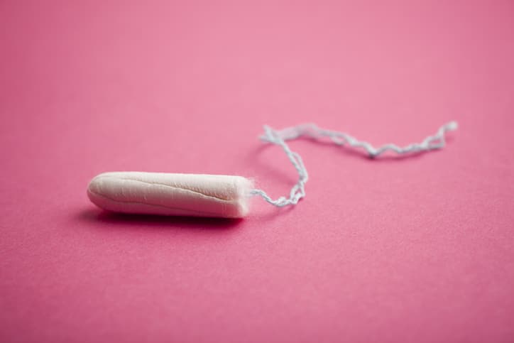 Period products: a tampon on a pink background