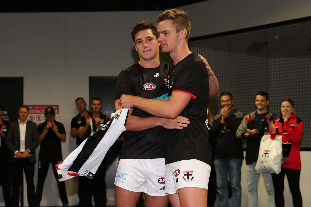 SYDNEY, AUSTRALIA - MARCH 21: Jack Steele of the Saints presents Thomas Highmore of the Saints with his jersey on debut during the round one AFL match between the GWS Giants and the St Kilda Saints at GIANTS Stadium on March 21, 2021 in Sydney, Australia. (Photo by Cameron Spencer/AFL Photos/via Getty Images)