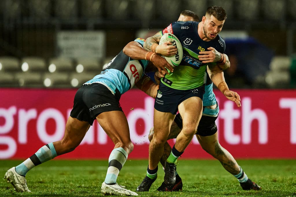 SYDNEY, AUSTRALIA - MARCH 21: Curtis Scott of the Raiders is tackled during the round two NRL match between the Cronulla Sharks and the Canberra Raiders at Netstrata Jubilee Stadium, on March 21, 2021, in Sydney, Australia. (Photo by Brett Hemmings/Getty Images)