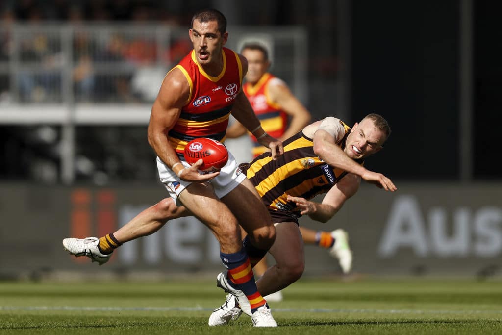 LAUNCESTON, AUSTRALIA - APRIL 25: Taylor Walker of the Crows fends off Tom Mitchell of the Hawks during the 2021 AFL Round 06 match between the Hawthorn Hawks and the Adelaide Crows at UTAS Stadium on April 25, 2021 in Launceston, Australia. (Photo by Dylan Burns/AFL Photos via Getty Images)