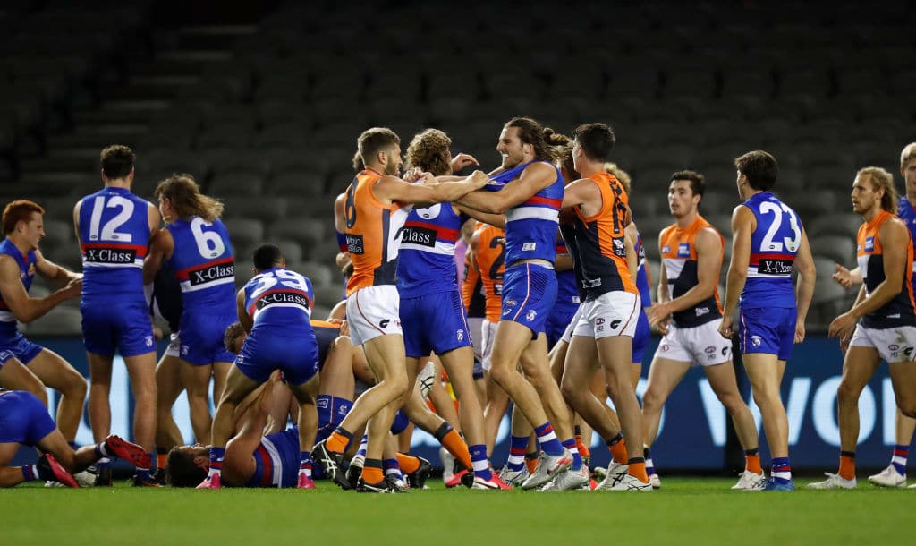 MELBOURNE, AUSTRALIA - JUNE 19: Players wrestle during the 2020 AFL Round 03 match between the Western Bulldogs and the GWS Giants at Marvel Stadium on June 19, 2020 in Melbourne, Australia. (Photo by Michael Willson/AFL Photos via Getty Images)