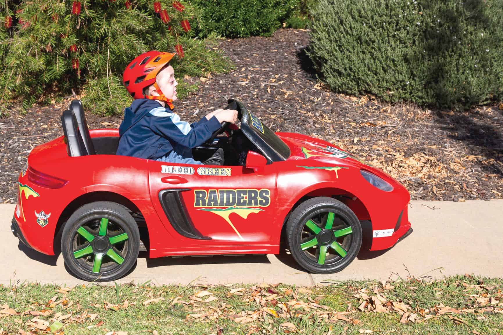 Cooper Hadley driving in his toy car