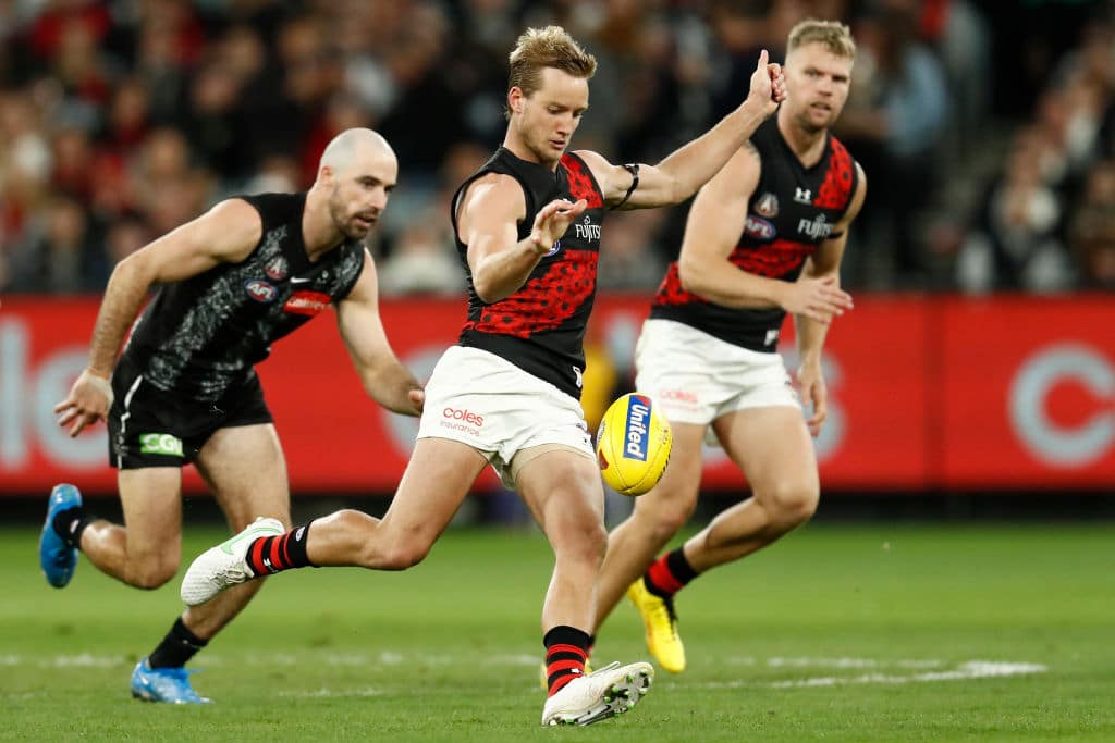 MELBOURNE, AUSTRALIA - APRIL 25: Darcy Parish of the Bombers kicks the ball during the round six AFL match between the Collingwood Magpies and the Essendon Bombers at Melbourne Cricket Ground on April 25, 2021 in Melbourne, Australia. (Photo by Darrian Traynor/AFL Photos/via Getty Images )