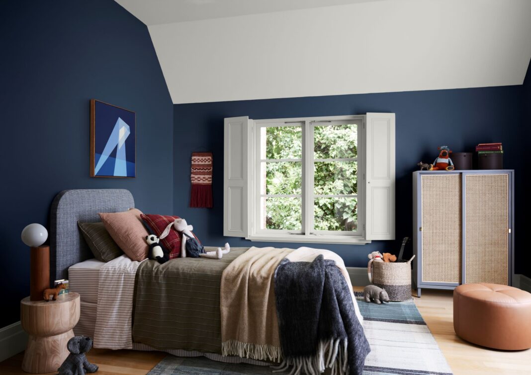 a child's bedroom decorated in shades of blue with warm accessories