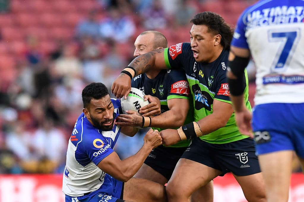BRISBANE, AUSTRALIA - MAY 15: Tuipulotu Katoa of the Bulldogs is tackled by Josh Hodgson and Josh Papalii of the Raiders during the round 10 NRL match between the Canterbury Bulldogs and the Canberra Raiders at Suncorp Stadium, on May 15, 2021, in Brisbane, Australia. (Photo by Albert Perez/Getty Images)
