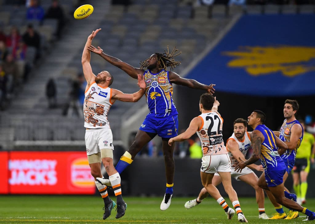 PERTH, AUSTRALIA - AUGUST 23: Shane Mumford of the Giants competes in a ruck contest with Nic Naitanui of the Eagles during the 2020 AFL Round 13 match between the West Coast Eagles and the GWS Giants at Optus Stadium on August 23, 2020 in Perth, Australia. (Photo by Daniel Carson/AFL Photos via Getty Images)