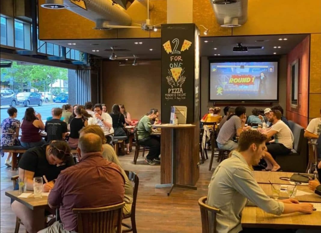 At least nine tables full of patrons at a bar in Canberra