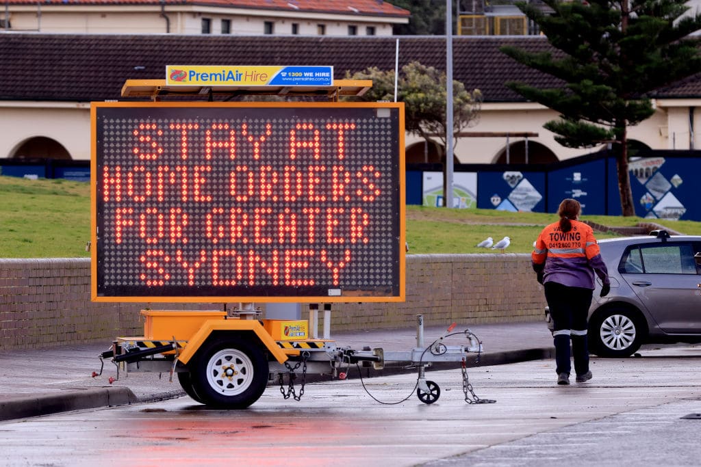 SYDNEY, AUSTRALIA - JUNE 29: A COVID-19 Notice is seen at Bondi beach on June 29, 2021 in Sydney, Australia. Lockdown restrictions continue across Great Sydney, the Blue Mountains, the Central Coast and Wollongong as NSW health authorities work to contain a growing COVID-19 cluster. From 6pm on Saturday 26 June, all residents in areas subject to stay-at-home orders are only permitted to leave their homes for essential reasons, including purchasing essential goods, accessing or providing care/healthcare, work, education and exercise. The restrictions will remain in place until midnight on Friday 9 July. (Photo by Mark Evans/Getty Images)