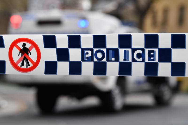 blue and white check Police tape restricts access to a street in NSW