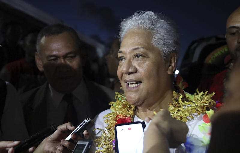 Samoa's first female Prime Minister-elect Fiame Naomi Mata'afa talks to reporters outside parliament house in Apia, Samoa