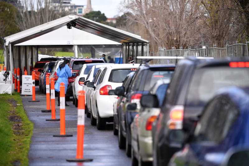 Cars are seen waiting in line at a drive-through covid19 testing facility in Melbourne