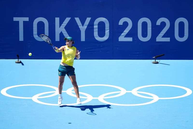 Australian champion tennis player Ash Barty dressed in green and gold practising on the Tokyo Olympics practice court