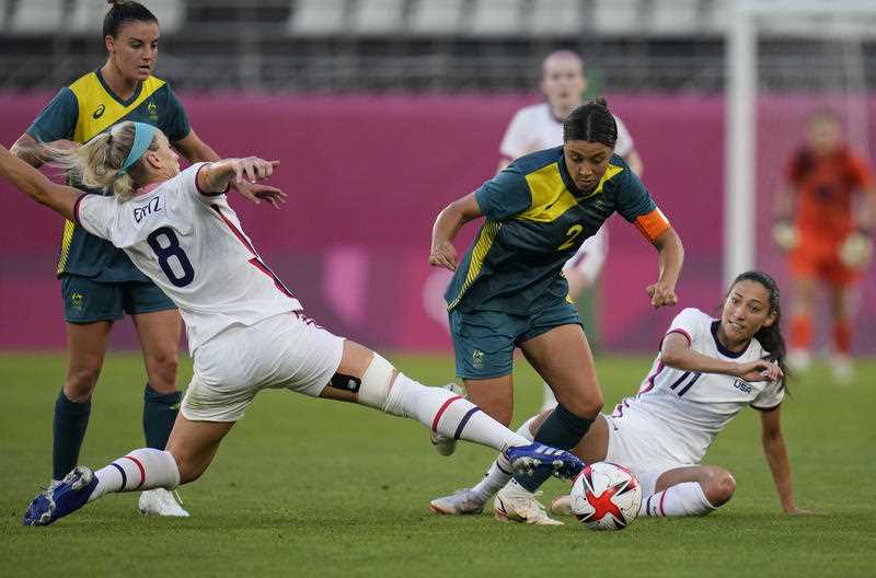 Australia's Sam Kerr, 2nd right, and United States' Julie Ertz, left, battle for the ball during a women's soccer match at the 2020 Summer Olympics